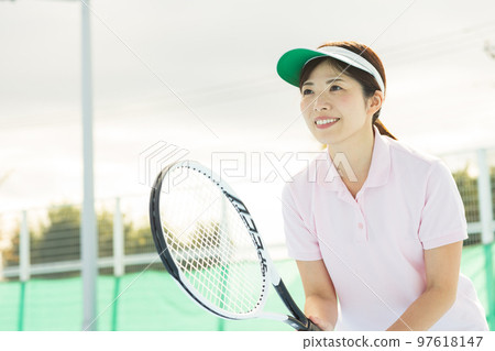 A woman enjoying tennis A woman enjoying tennis 97618147