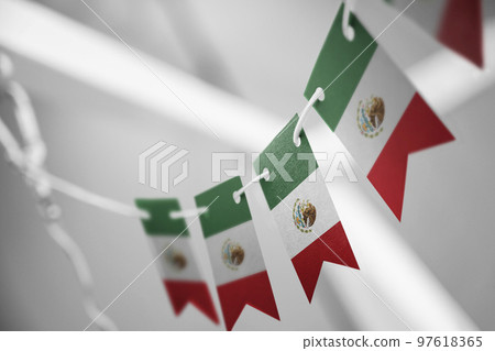 A garland of Mexico national flags on an abstract blurred background A garland of Mexico national flags on an abstract blurred background 97618365