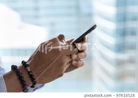 Mobile phone in male hands close up side view shot Mobile phone in male hands close up side view shot 97618528