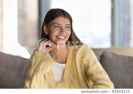 Joyful pretty young woman indoor candid portrait 97618535