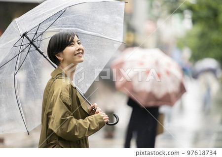 Young woman holding a vinyl umbrella Young woman holding a vinyl umbrella 97618734