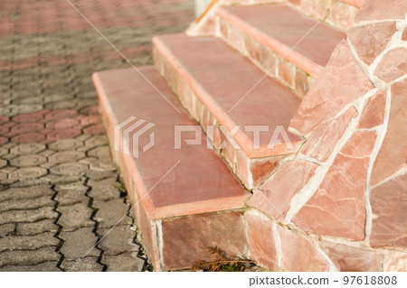 Architecture wide outside pink staircase made of granite pavement in the front yard. Wide concrete staircase closeup Architecture wide outside pink staircase made of granite pavement in the front yard. Wide concrete staircase closeup 97618808
