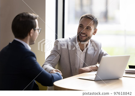 Two business partners finish successful negotiations with shake hands Two business partners finish successful negotiations with shake hands 97618842