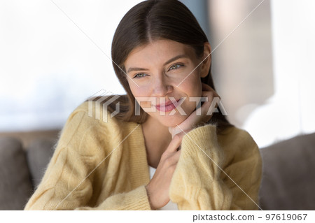 Positive dreamy pretty young woman wearing sift warm sweater 97619067