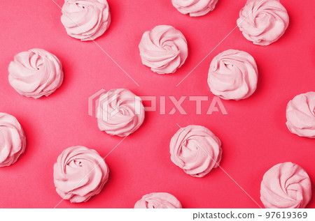 colorful marshmallows on magenta background. Color of year 2023. Viva magenta. Color sweet homemade zephyr colorful marshmallows on magenta background. Color of year 2023. Viva magenta. Color sweet homemade zephyr 97619369
