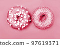 Color of year 2023. Viva Magenta. Two donuts with icing on pastel background. Copyspace 97619371