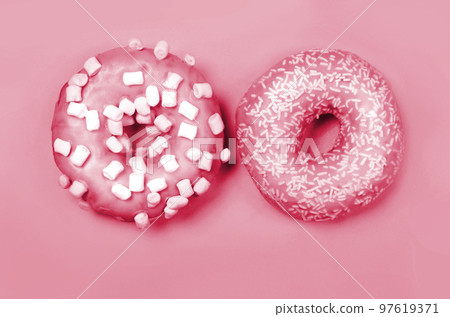 Color of year 2023. Viva Magenta. Two donuts with icing on pastel background. Copyspace Color of year 2023. Viva Magenta. Two donuts with icing on pastel background. Copyspace 97619371