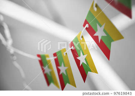 A garland of Myanmar national flags on an abstract blurred background 97619843
