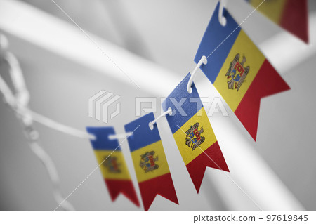 A garland of Moldavia national flags on an abstract blurred background 97619845