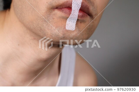 A man with anti-snoring tape A man with anti-snoring tape 97620930