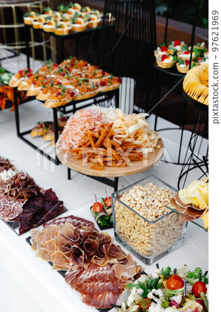 Buffet table of reception with cold snacks, meat and salads 97621969