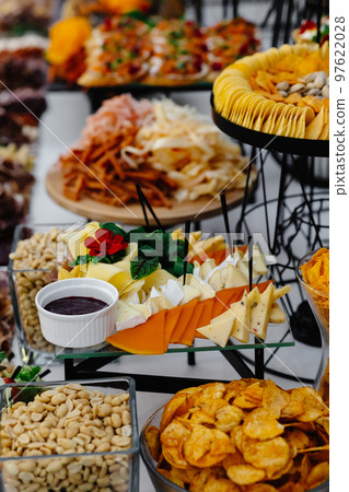 Buffet table of reception with cold snacks, meat and salads 97622028