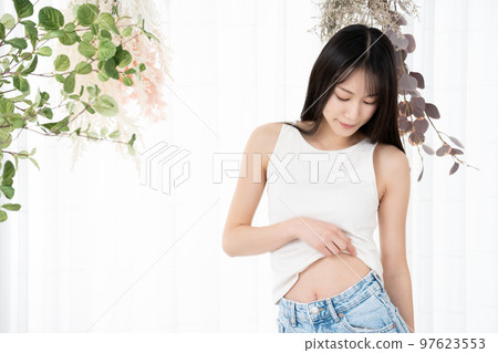 Young woman checking her waist 97623553