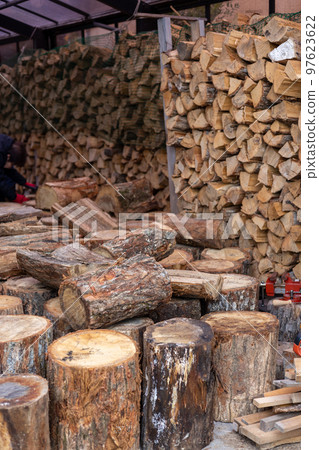 Stacked firewood for a wood stove and logs brought in 97623622