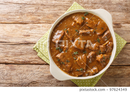Belgian Carbonnade Beef and Beer Stew closeup in the pot. Horizontal top view 97624349