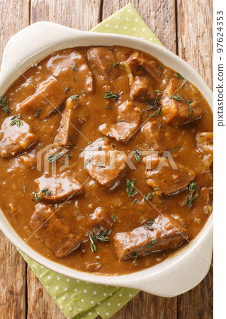 Carbonnade a la Flamande Flemish Beef Stew closeup on the pot. Vertical top view Carbonnade a la Flamande Flemish Beef Stew closeup on the pot. Vertical top view 97624353
