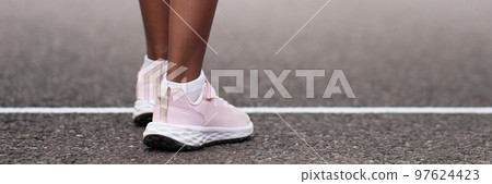 Start line, child in sneakers standing on the starting line Start line, child in sneakers standing on the starting line 97624423