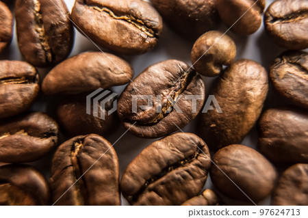 Falling Roasted Coffee Beans, Macro Shot, close-up. 97624713
