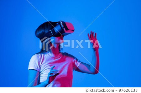 Young brunette woman in white t-shirt wearing vr headset. Metaverse concept vr future girl. Young brunette woman in white t-shirt wearing vr headset. Metaverse concept vr future girl. 97626133