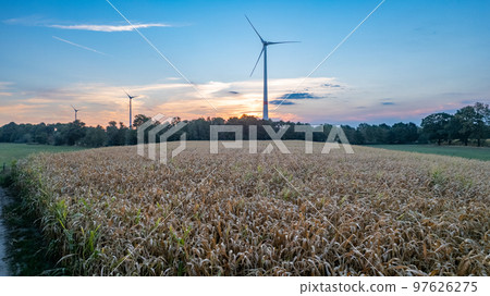Wind farm with wind Turbine in a rural area against the sunset seen from an aerial view shot by a Wind farm with wind Turbine in a rural area against the sunset seen from an aerial view shot by a 97626275