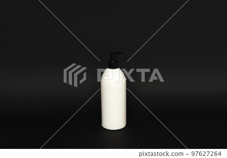 White unbranded bottle with a black dispenser isolated on black background. cosmetic packaging mockup with copy space. Bottle for a shower, gel, soap. 97627264