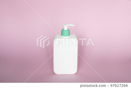 White unbranded bottle with a dispenser isolated on pink background. cosmetic packaging mockup with copy space. Bottle for a shower, gel, soap. 97627266