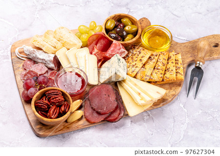Antipasto board with prosciutto, salami, crackers, cheese Antipasto board with prosciutto, salami, crackers, cheese 97627304