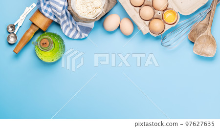 Cooking ingredients and utensils on blue background Cooking ingredients and utensils on blue background 97627635