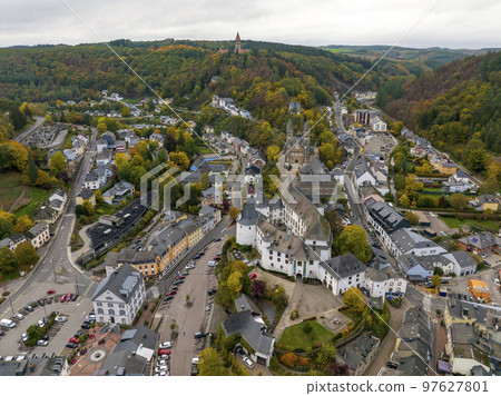 Aerial drone Shot of town CLervaux on the north of Luxembourg. Twilight evening scene with Castle and Cathedral Aerial drone Shot of town CLervaux on the north of Luxembourg. Twilight evening scene with Castle and Cathedral 97627801