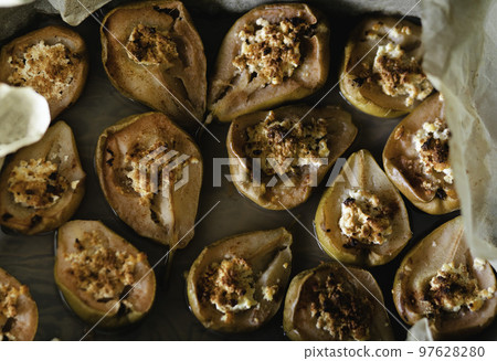 Halves of tasty baked pears with maple syrup and cinnamon on wax paper Halves of tasty baked pears with maple syrup and cinnamon on wax paper 97628280