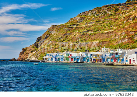 Colorful village of Klima with traditional Greek houses, Milos, Greece. Whitewashed houses with painted doorways and boat garages on sunny summer day. 97628348