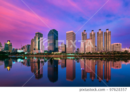 Skyline of highrises reflecting in lake waters at sunset. Bangkok, Thailand. Beautiful landscape, residential area. Skyline of highrises reflecting in lake waters at sunset. Bangkok, Thailand. Beautiful landscape, residential area. 97628357