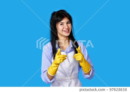 woman in gloves and cleaner apron pointing fingers to camera woman in gloves and cleaner apron pointing fingers to camera 97628638