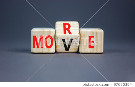 More move symbol. Concept word More move on wooden cubes. Beautiful grey table grey background. Business and more move concept. Copy space. 97630394