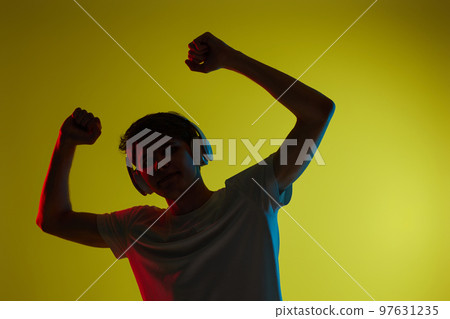 Young man listening to music with headphones Young man listening to music with headphones 97631235