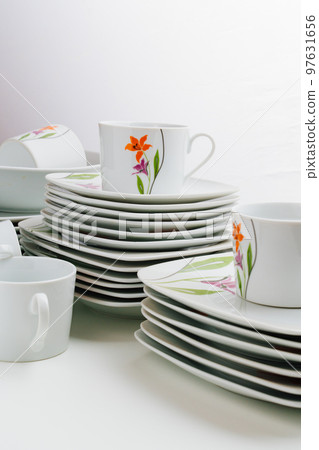 cups and plates with the image of flowers  97631656