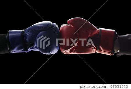 Two men's hands in boxing gloves. The concept of confrontation. Photo on a black background 97631923
