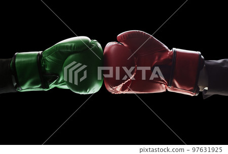 Two men's hands in boxing gloves. The concept of confrontation. Photo on a black background 97631925