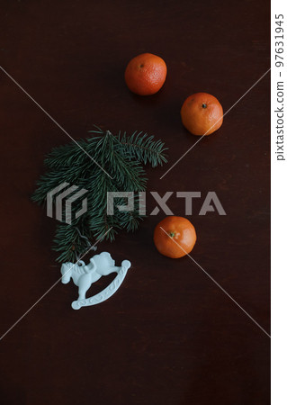 Christmas Toy horse, tangerines and pine cone. Winter holiday items for home decor. Flat lay 97631945
