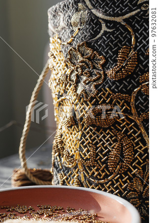 bag of precious stones sits on table, soft selective focus. bead embroidery, hobby design  97632081