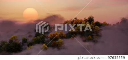 Colorful Trees on top of Mountain Landscape covered in fog. Sunset. Nature Background. 97632359