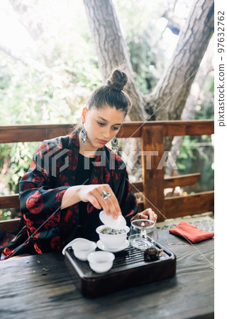 Process brewing tea. Woman steeping herbal tea Process brewing tea. Woman steeping herbal tea 97632762