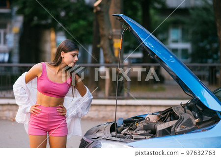 Woman with broken car on the road. Look for help. Woman with broken car on the road. Look for help. 97632763