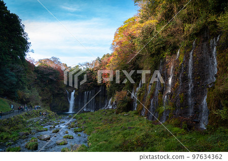 Autumn colors make the waterfalls in the forest Japan Autumn colors make the waterfalls in the forest Japan 97634362