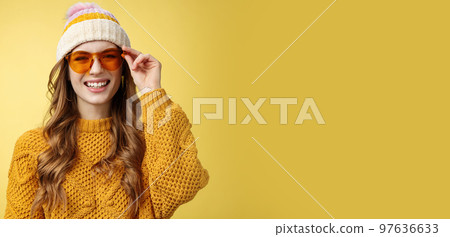 Friendly-looking happy outgoing attractive girl laughing joyfully having funny interesting conversation checking sunglasses relaxing ski resort having fun resting together friends, yellow background Friendly-looking happy outgoing attractive girl laughing joyfully having funny interesting conversation checking sunglasses relaxing ski resort having fun resting together friends, yellow background 97636633