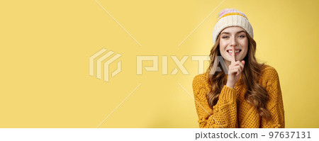 Shush listen. Portrait attractive flirty smiling devious cute european woman have secret showing shh gesture index finger pressed lips sharing interesting rumor, standing happily yellow background Shush listen. Portrait attractive flirty smiling devious cute european woman have secret showing shh gesture index finger pressed lips sharing interesting rumor, standing happily yellow background 97637131