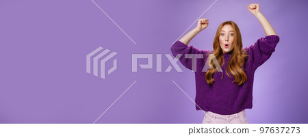 Excited and thrilled woman reacting to unexpected goal raising hands in wave gesture folding lips inhaling breath to scream yes and wow being impressed, triumphing from success and good news Excited and thrilled woman reacting to unexpected goal raising hands in wave gesture folding lips inhaling breath to scream yes and wow being impressed, triumphing from success and good news 97637273