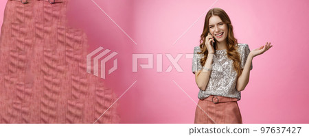 Sociable friendly-looking smiling happy glamour rich girl talking smartphone calling friend pleasant funny conversation laughing out loud joking gesturing talk mobile phone, pink background 97637427
