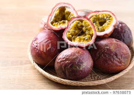 Passion fruit in basket on wooden background, Tropical fruit in summer season Passion fruit in basket on wooden background, Tropical fruit in summer season 97638073