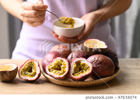 Woman eating passion fruit, Healthy food, Tropical fruit in summer season 97638074